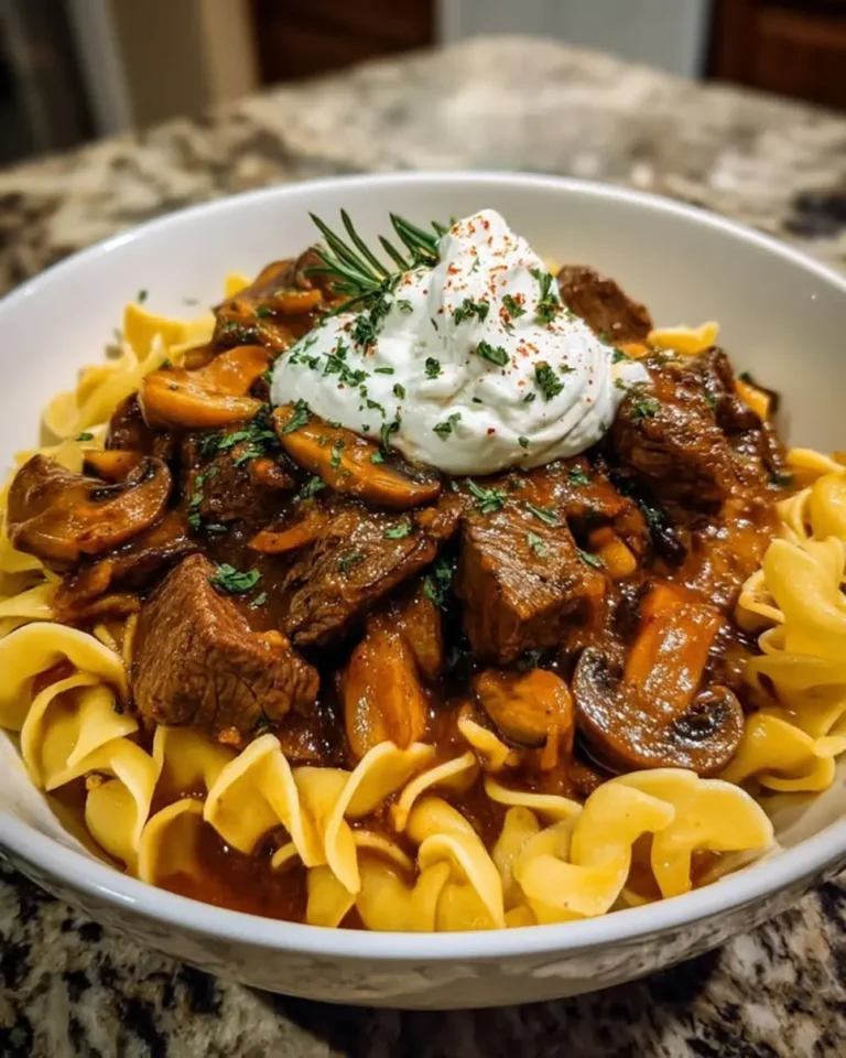 Craving comfort food? Make Creamy Slow Cooker Beef Tips and Noodles in 5 easy steps! Discover this simple, hearty recipe now.